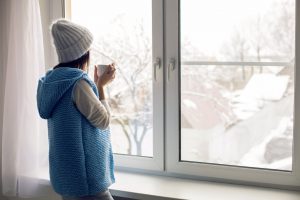 woman looks chilly in her home